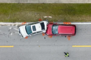 Red and white cars crashed together on the road illustrating collision cases handled by a Sandy Springs car accident attorney