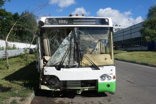 Accident scene with crashed city bus representing need for a bus accident lawyer.