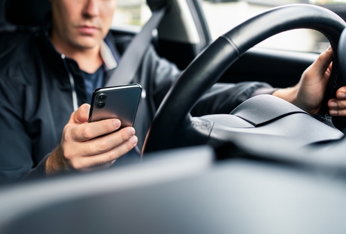 Distracted driver using phone before crash — Roswell rideshare accident lawyer helping victims of negligent rideshare drivers.