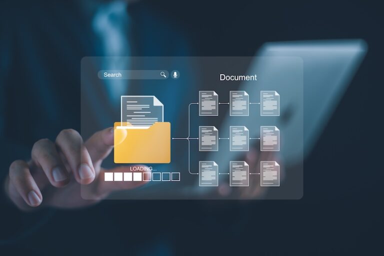 A lawyer from Horst Shewmaker in a dark business suit reaches one hand forward to touch a glowing translucent digital interface floating in the air in front of a blurred tablet device displaying a yellow file folder icon labeled LOADING with a progress bar beneath it connected by branching lines to nine individual document icons arranged in a three-by-three grid under the heading Document with a search bar visible at the top — representing the digital organization and retrieval of medical records- police reports- and legal paperwork needed to build a strong car accident claim.
