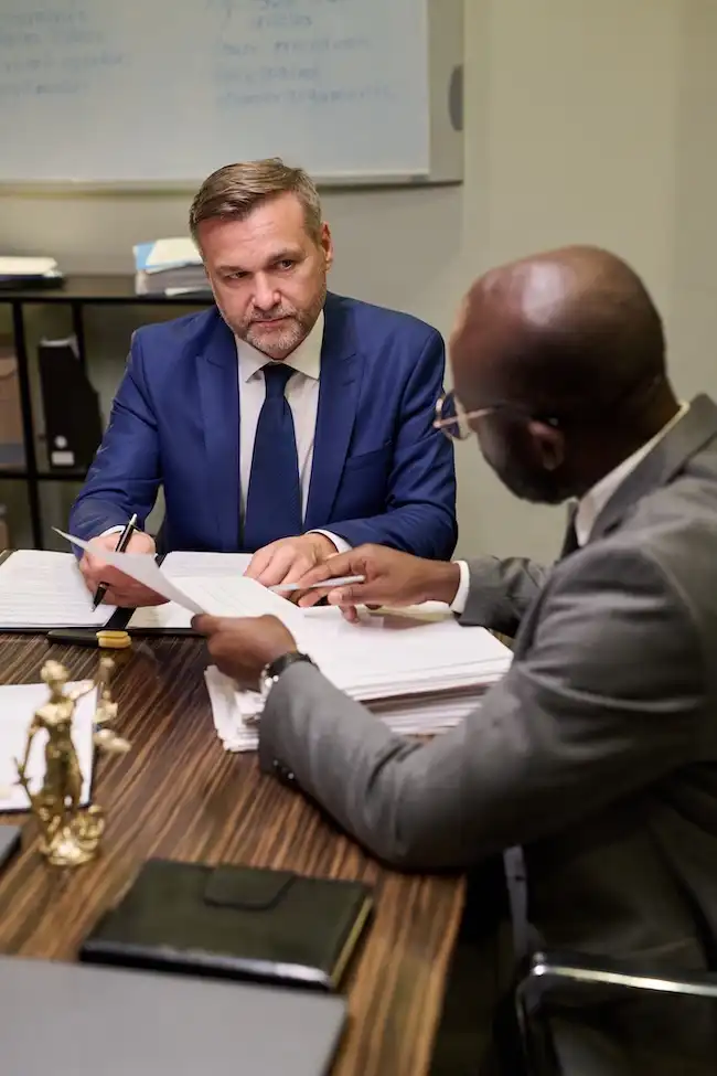 Attorney negotiating with insurance company representative for car accident client settlement