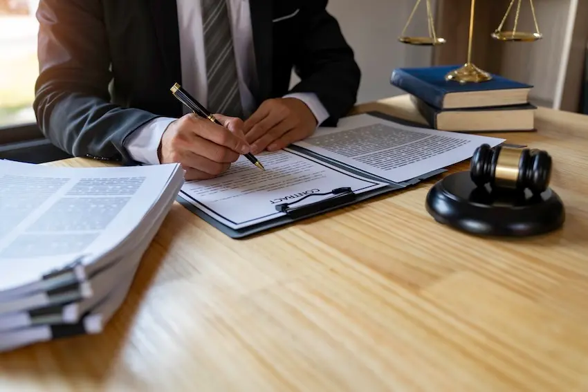 Alpharetta car accident lawyer reviewing medical records to investigate sudden emergency defense claim in Georgia