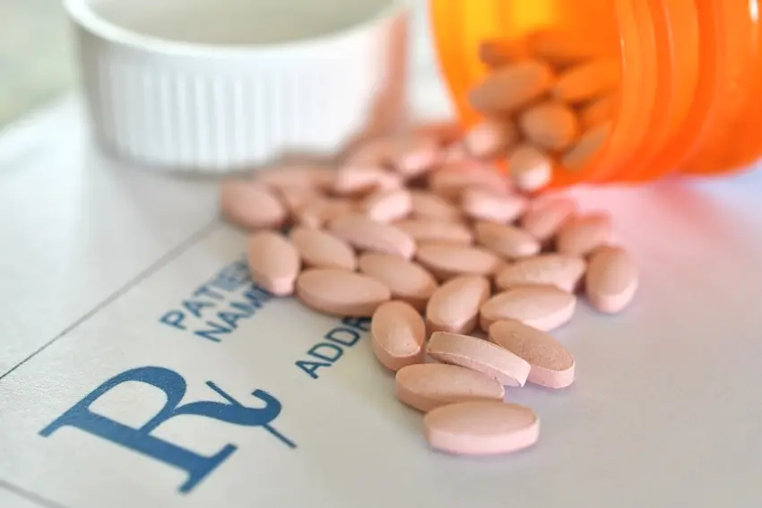 Georgia driver's license next to prescription medication representing medical driving restrictions and car accident liability
