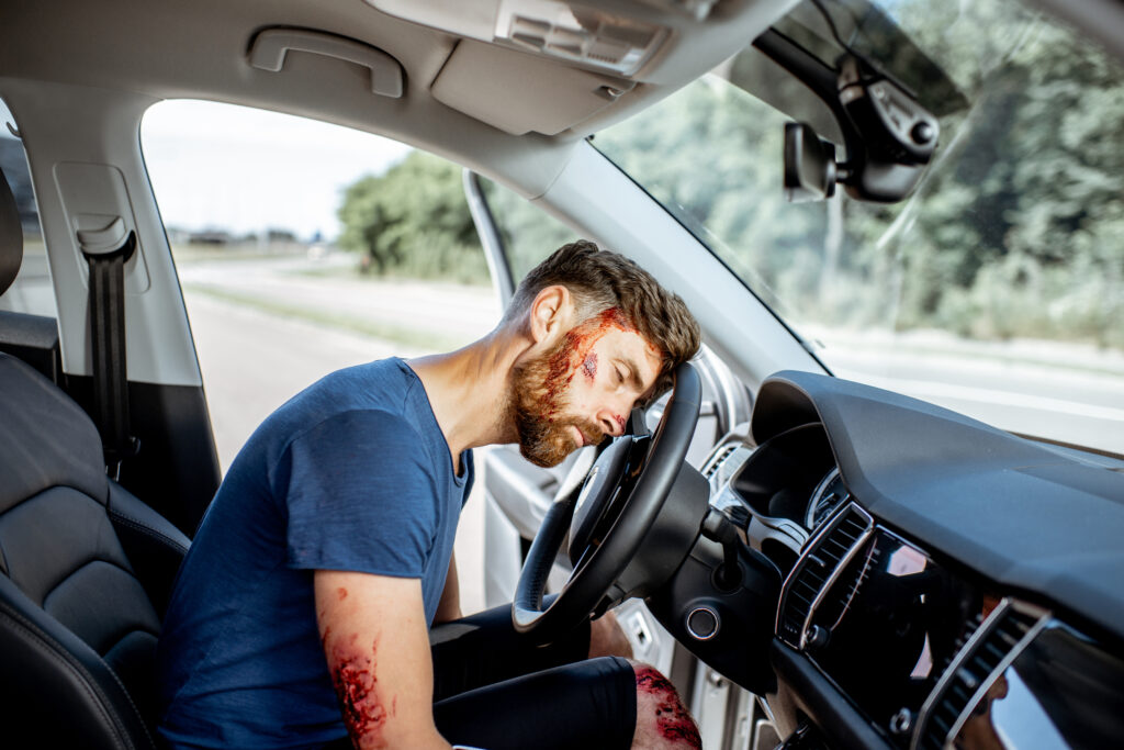 Driver slumped over steering wheel after suffering a medical emergency causing a car accident in Georgia