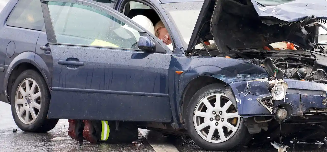 An emergency responder is tending to a passenger who was in a car accident in Georgia.