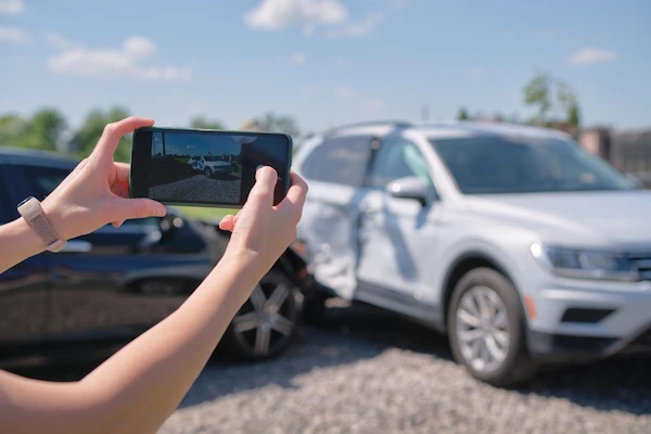 A driver taking photos knows what to do after a car accident in Alpharetta.
